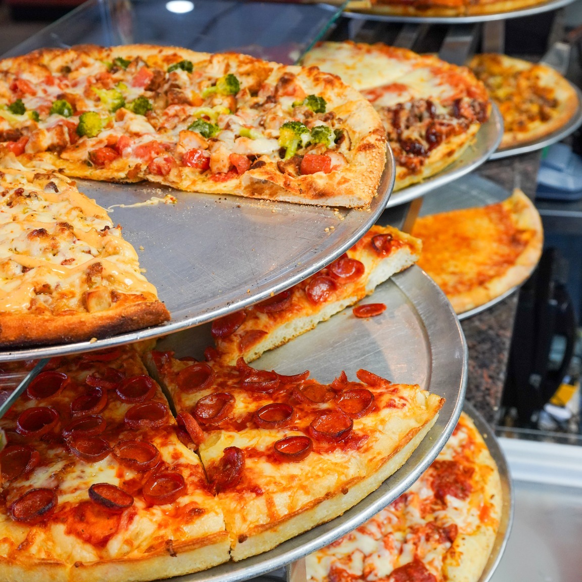 Fresh slices ready in the display case at Carlo's in Shirley